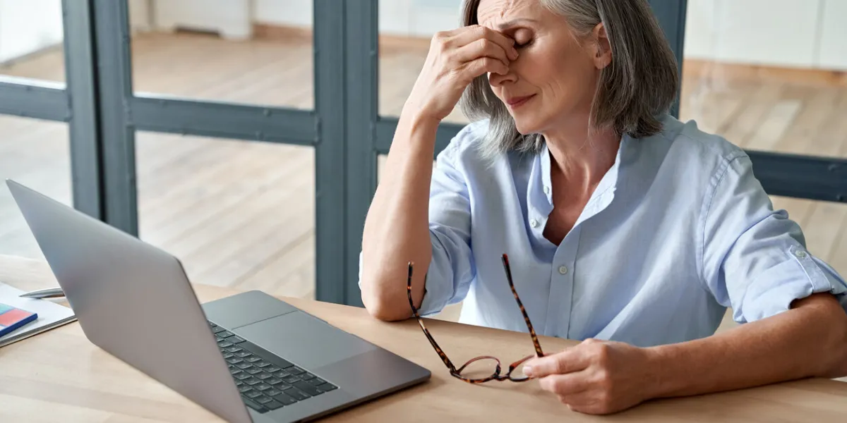 overworked tired older lady holding glasses feeling headache, having eyesight problem after computer work stressed mature senior business woman suffering from fatigue rubbing dry eyes at workplace