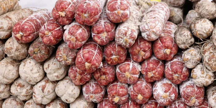 traditional meat products sold at a street stall during the farmers market in cremona, lombardy, italy