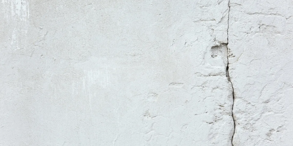 texture and background white old concrete wall with a crack repair and construction