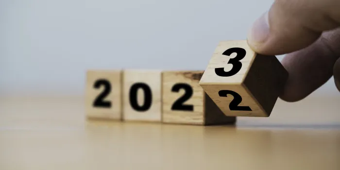 wooden block cube flipping between 2022 to 2023 for change and preparation merry christmas and happy new year