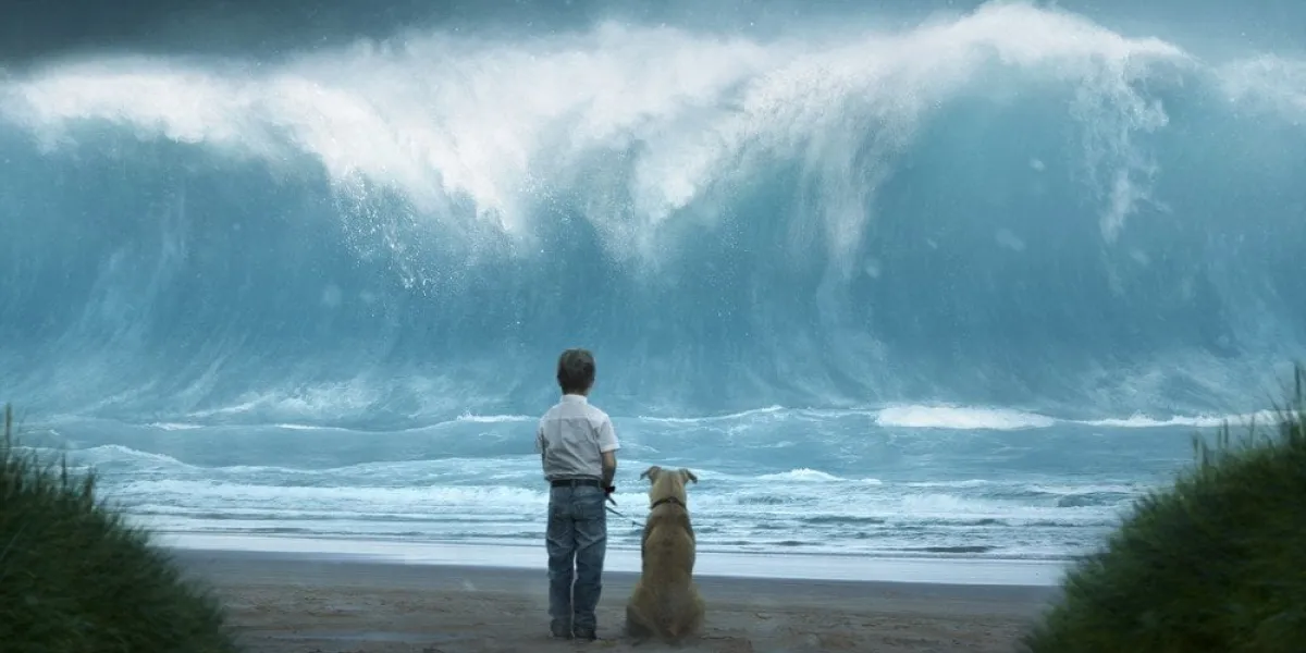 kleiner junge mit hund sieht riesenwelle auf sich zukommen