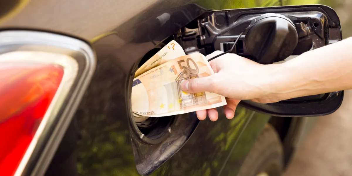 transportation expenses concept - euro money in car fuel tank
