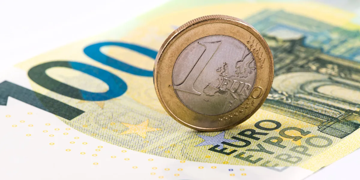 1 euro against the background of a banknote of 100 euros