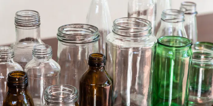 variety shape and color of empty glass container bottles, reuse waste things for ecology friendly concept, copy space