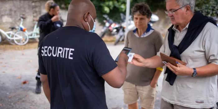 angers, maine et loire, france september 19 2021  security checking the sanitary pass at entrance, digital vaccine passport concept