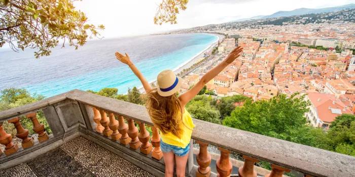 young female traveler enjoying great view on the nice city in france