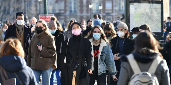 paris, france-03 06 2021 people wearing protective face masks in a crowded street of paris, france during the global coronavirus epidemic