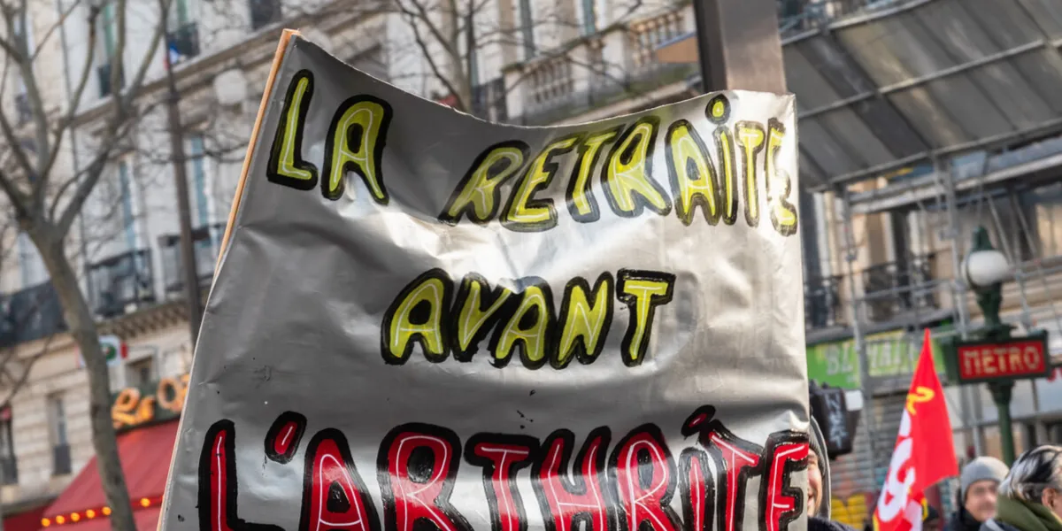 paris, france - january 24 2020   protest against the retirement pension reform of president macron - banner with the slogan retirement before arthritis