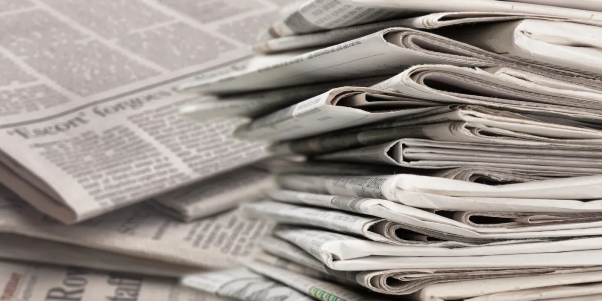 pile of newspapers on white background