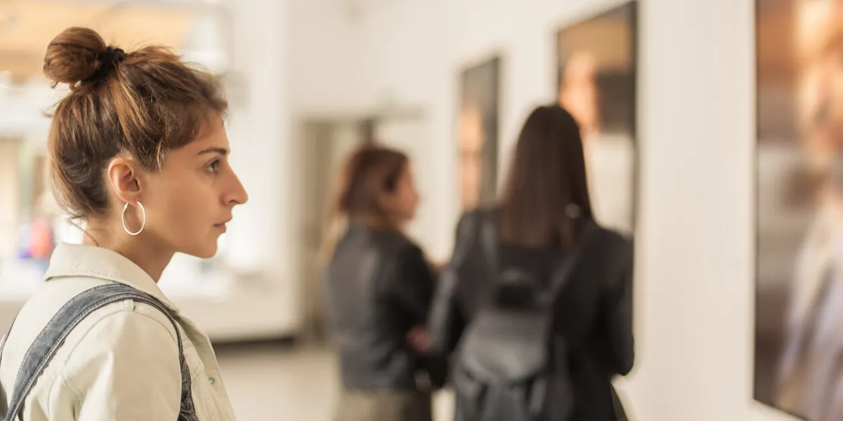 group of woman looking at modern painting in art gallery abstract painting