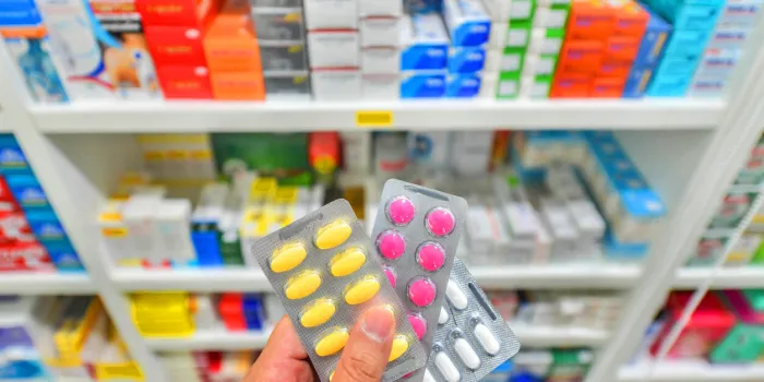 hand holding three medicine pack at the pharmacy drugstore