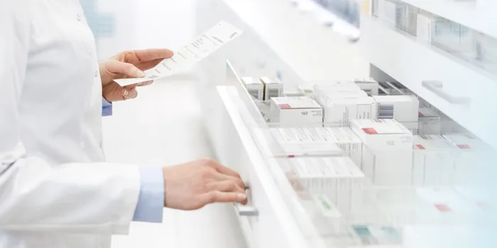 pharmacist filling prescription in pharmacy