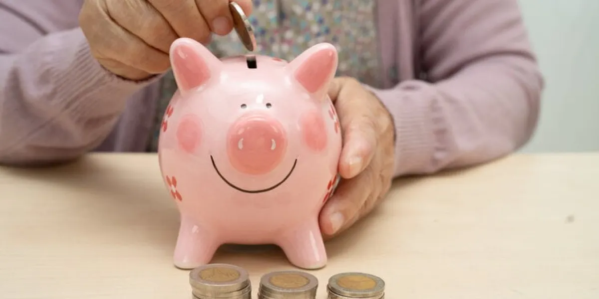retired elderly woman counting coins money with piggy bank and worry about monthly expenses and treatment fee payment