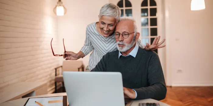 senior couple looking at a laptop computer