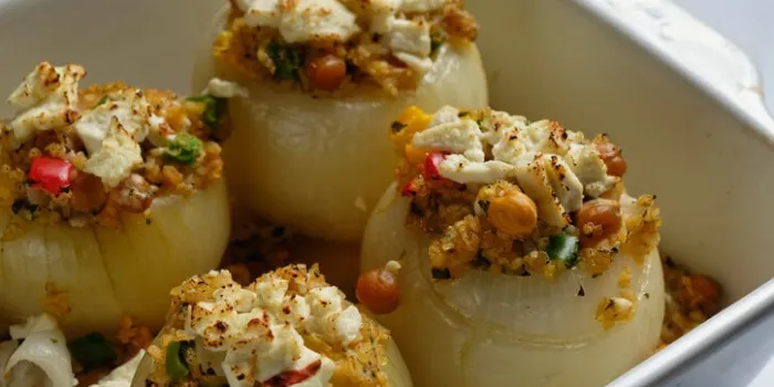 stuffed onions, with bulgur and vegetables, in a baking dish