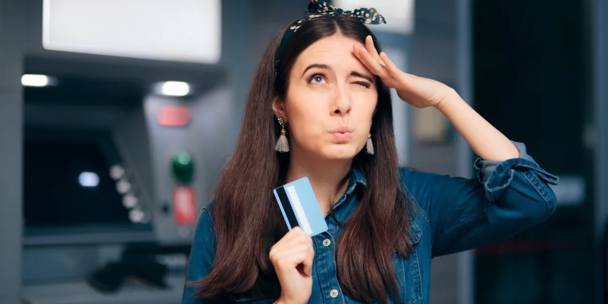 woman in front of atm machine forgetting pin number