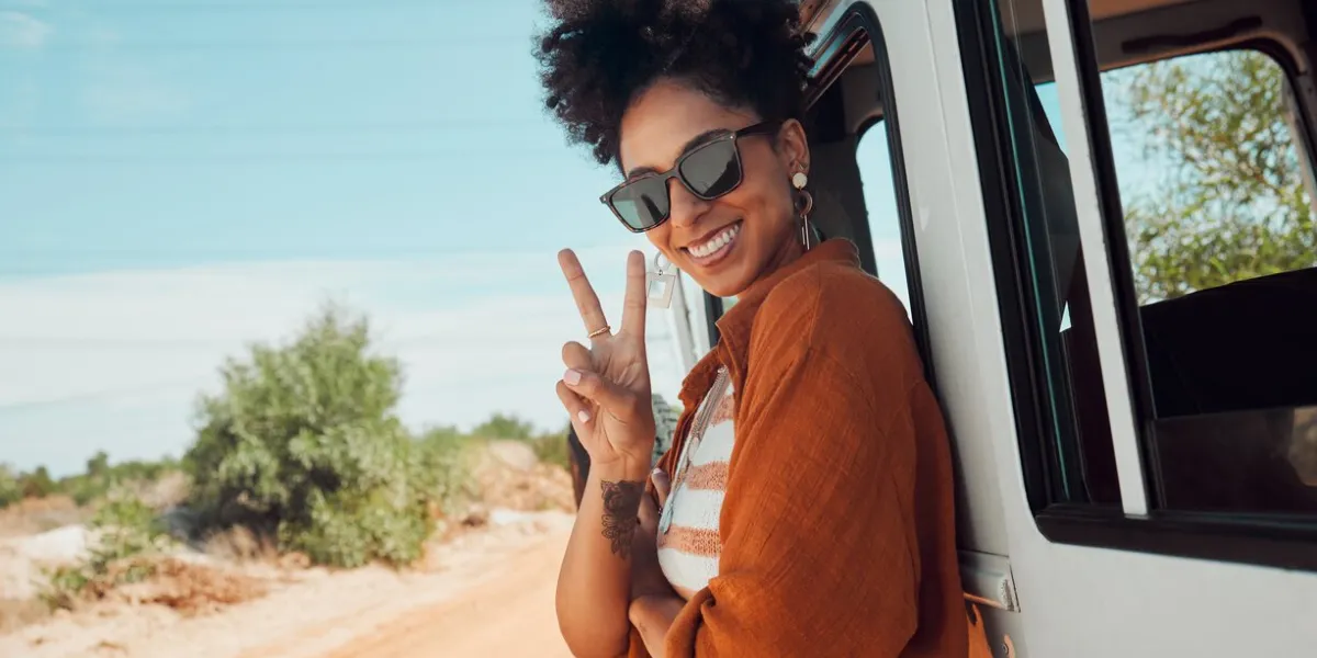 travel, van and woman with peace hand sign on road trip in mexico, happy, relax and smile summer, nature and journey in a countryside with a black woman excited about adventure and hipster lifestyle