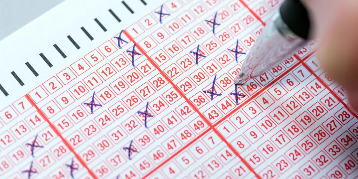 completing a lottery ticket with a pen and hoping for quick riches