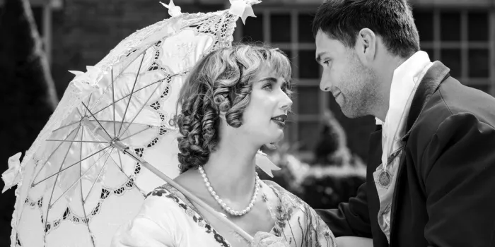 young couple dressed in vintage costume beautiful woman holds parasol while gazing into the eyes of her lover