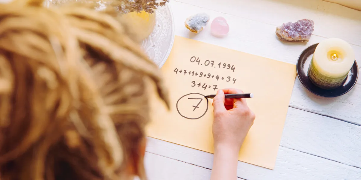 above view of girl calculate life path number on paper in home spiritual numerology concept