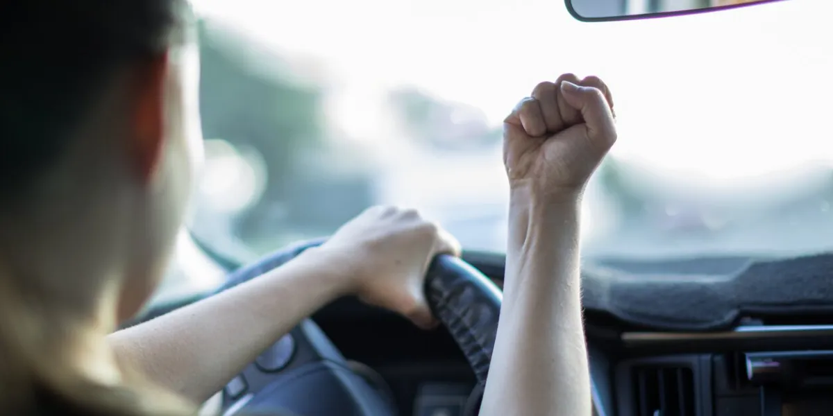 a reckless young female driver angry road rage, behind the wheel of a car