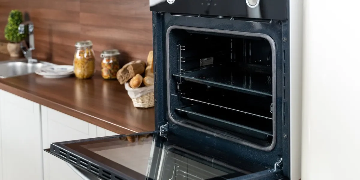 black new open oven on white rustic kitchen