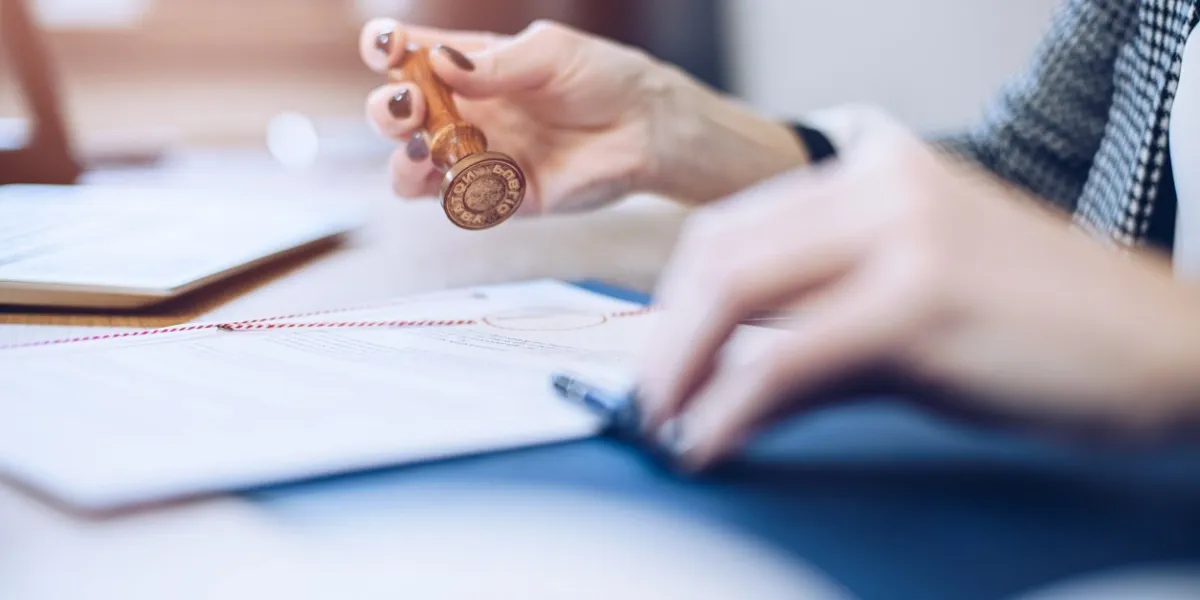 woman notary public or judge stamping and authorizing document in law office