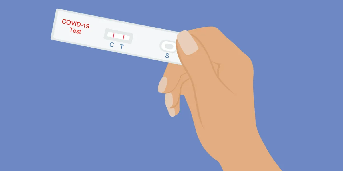 hand holding covid-19 rapid test with positive test result