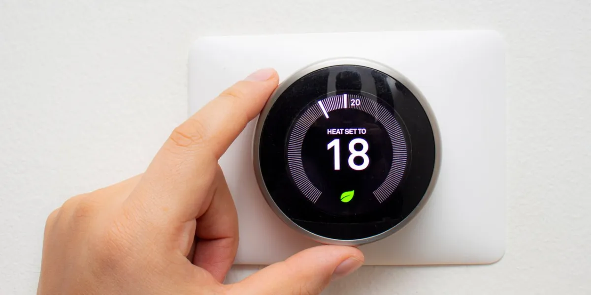 smart thermostat with a person saving energy with a soft shadow