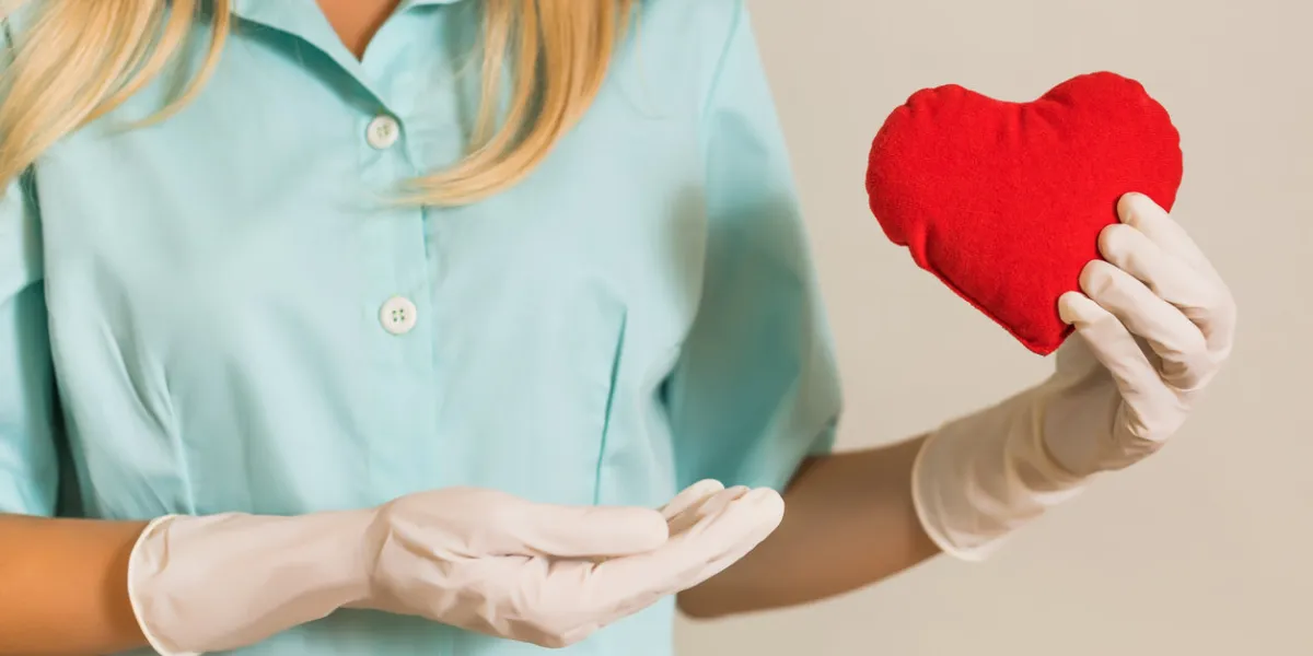 image of medical nurse holding red heart