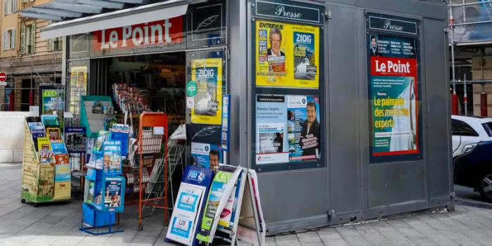 nice, france - april 27, 2023  there is a kiosk on the palais de justice square with magazines, newspapers and a selection of postcards, which are displayed here on external stands