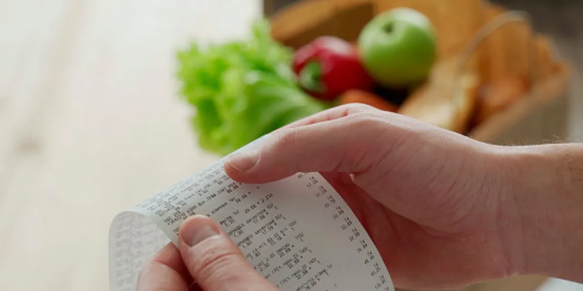 close-up woman looking a check from a supermarket expense tracking and budgeting