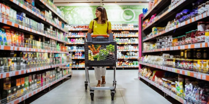 woman with shopping between store shelf copy space