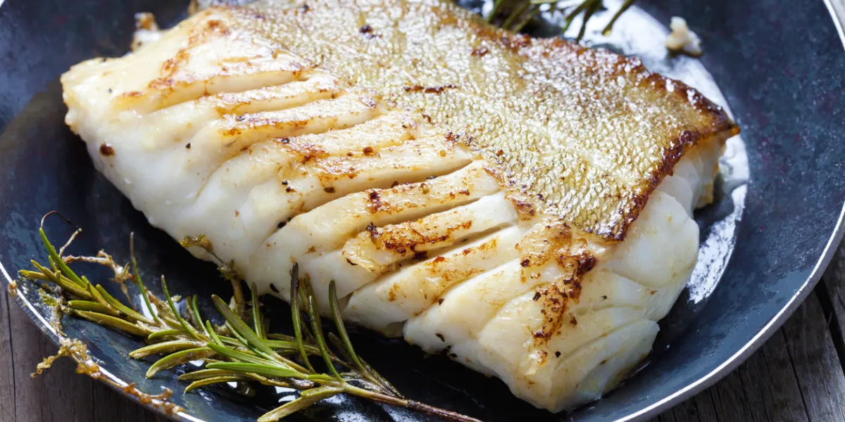 fried fish fillet, atlantic cod with rosemary in pan