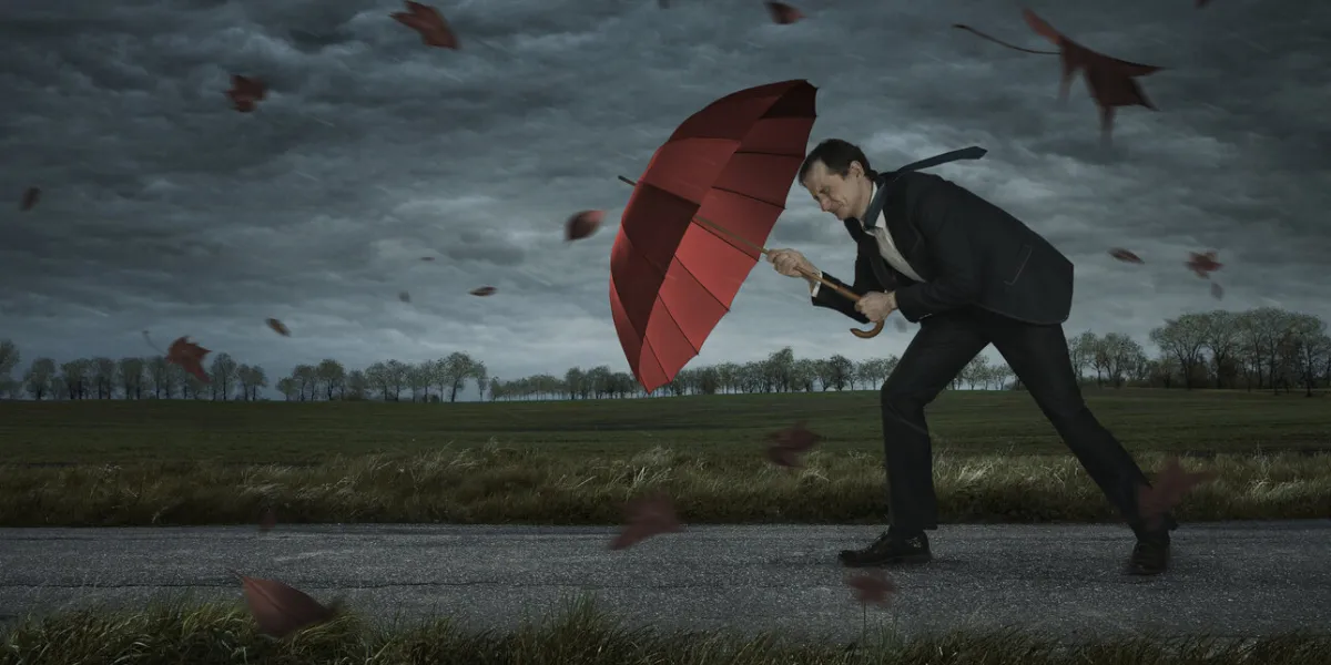 crisis, trouble, problems concept businessman walks in the storm with copy space
