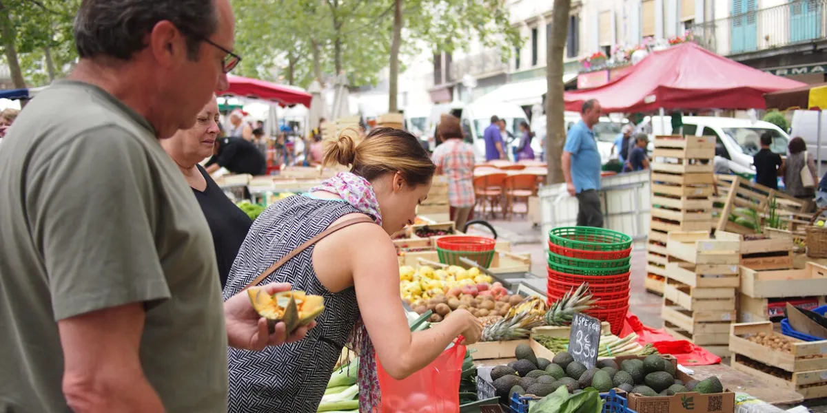 carcassonne, france - june 25, 2016  locals shop at a fruit and vegetable market in carcassone town centre