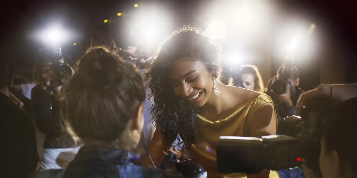 celebrity signing autographs for fans at event