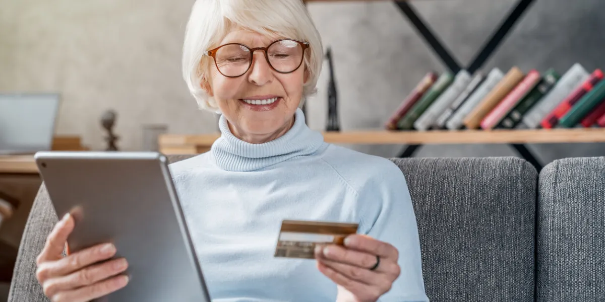 shopping online senior woman using tablet computer and credit card