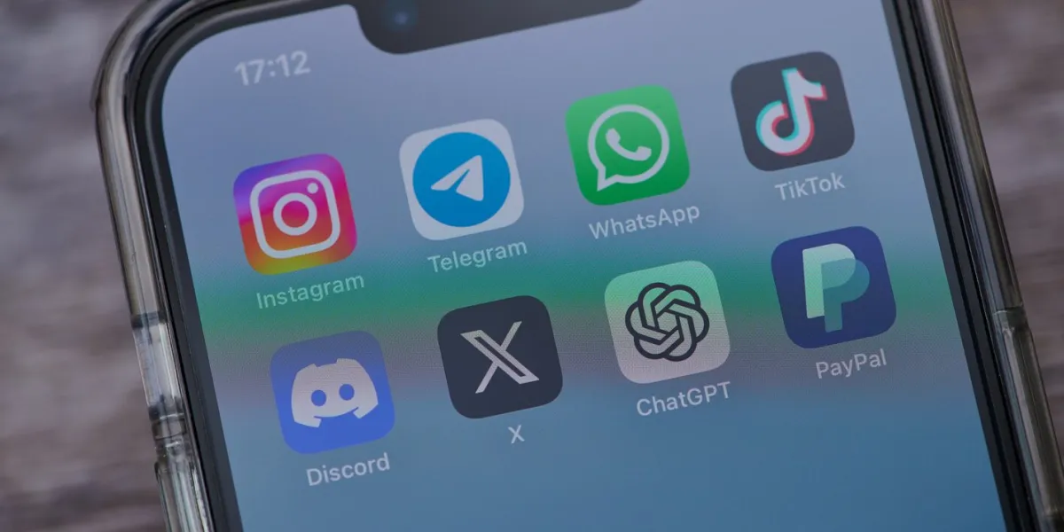 mainz, germany - august 02, 2023  close up of iphone on a table showing icons of the apps instagram, telegram, tiktok, twitter, discord, telegram, chatgpt and paypal