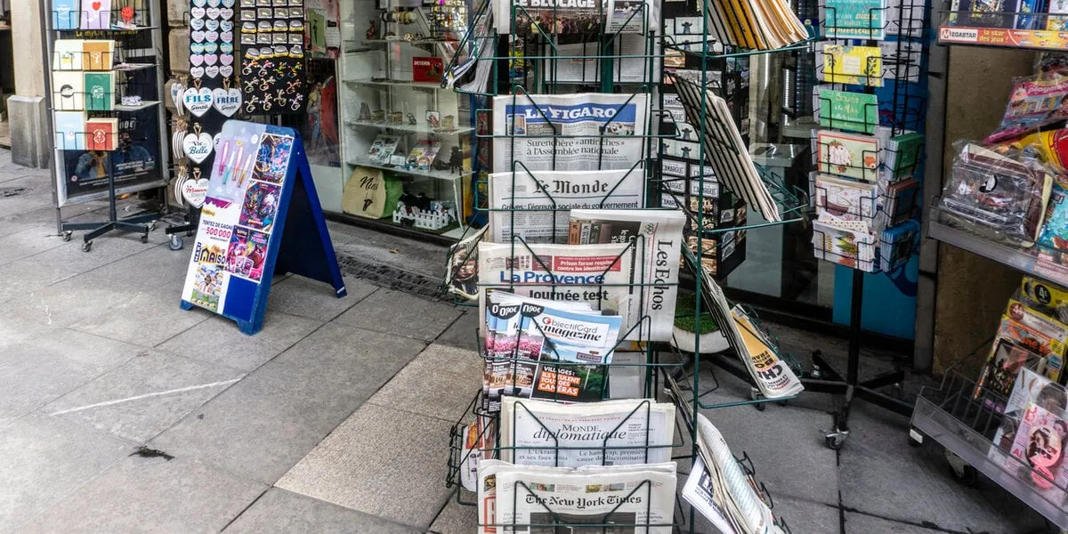newspapers and magazines for sale outside a shop in ni­mes, france