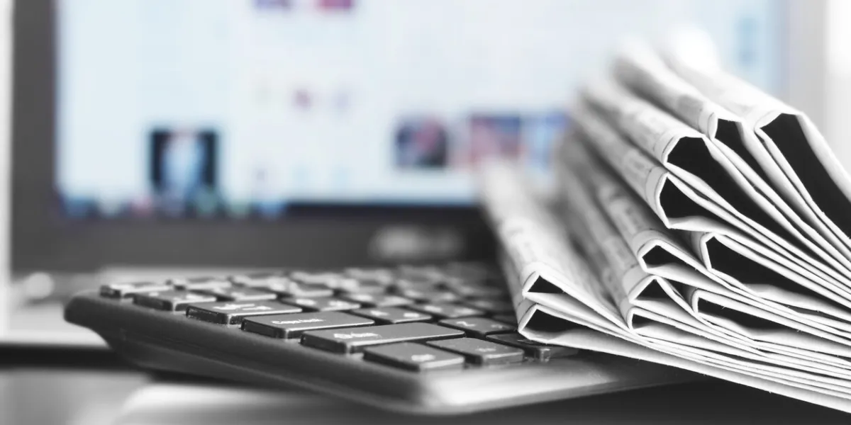 newspapers and laptop different concepts for news - social network or traditional tabloid journals data sources - electronic screen of computer or paper pages of magazines, internet or papers