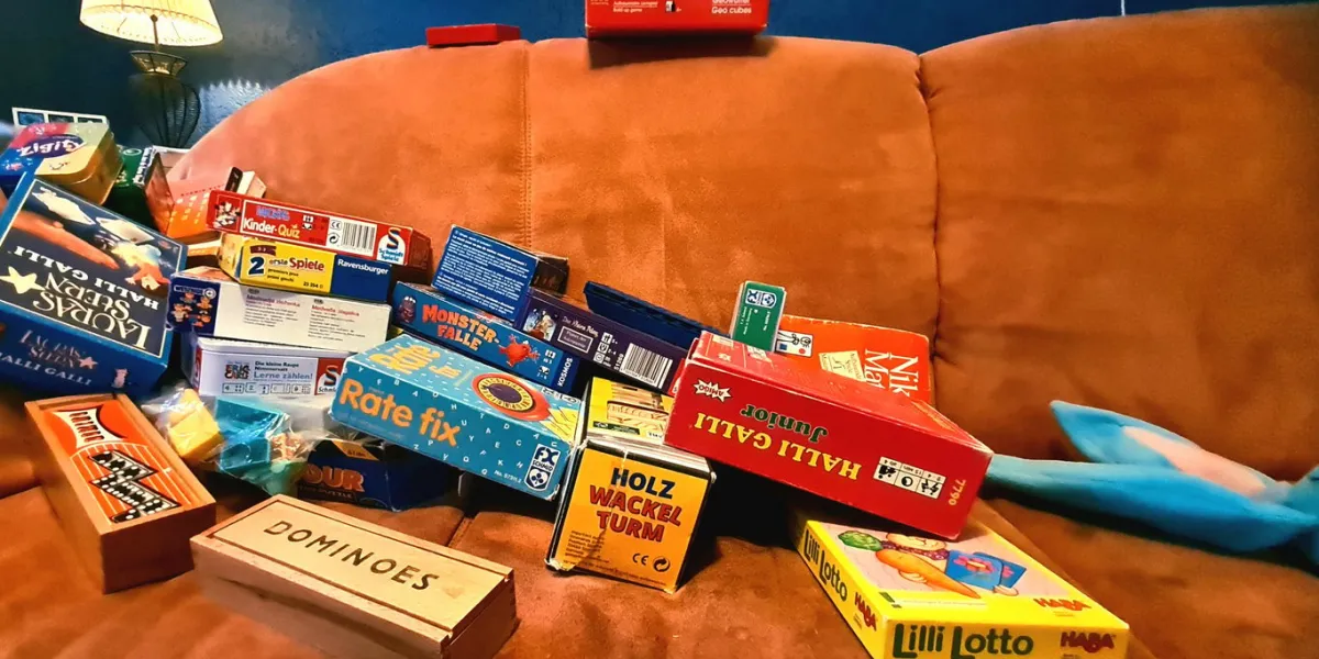 games collection, terracotta sofa in front of blue wall