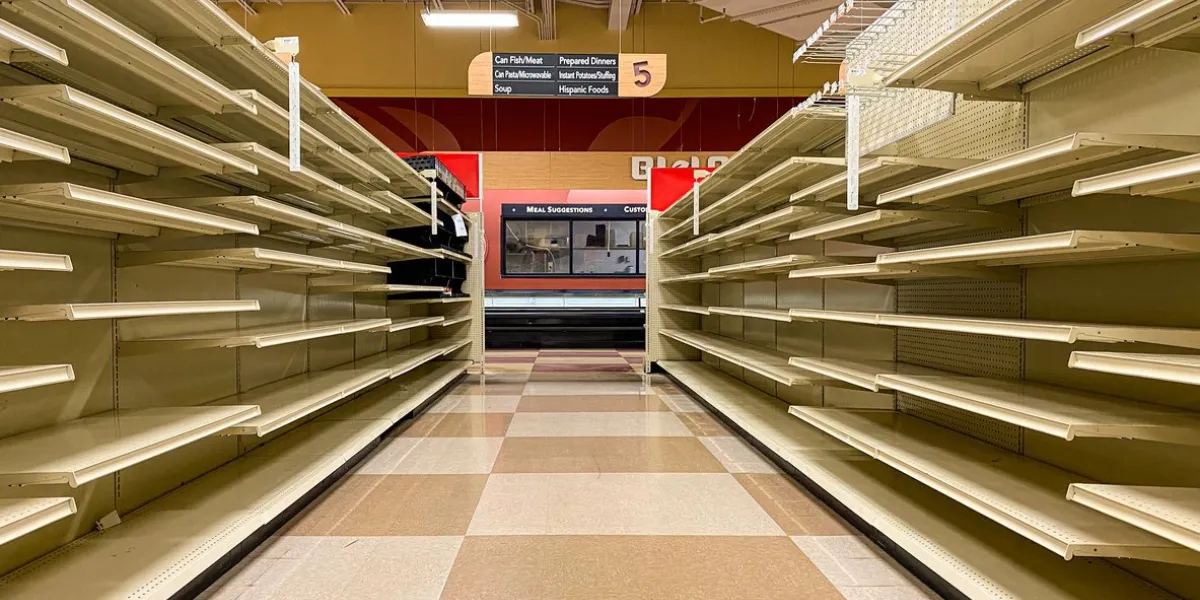 the aisles of a local grocery store chain sits empty after the store announced it was liquidating all remaining stock and closing down