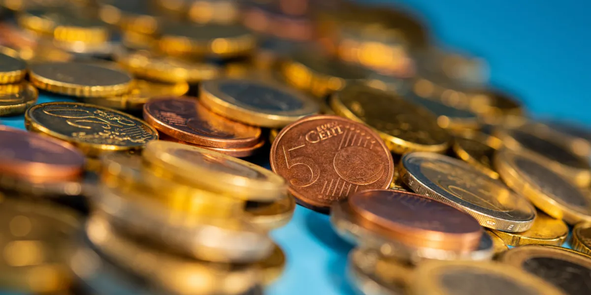 euro cents and coins of one and two euro denominations lie on a blue background photo for design