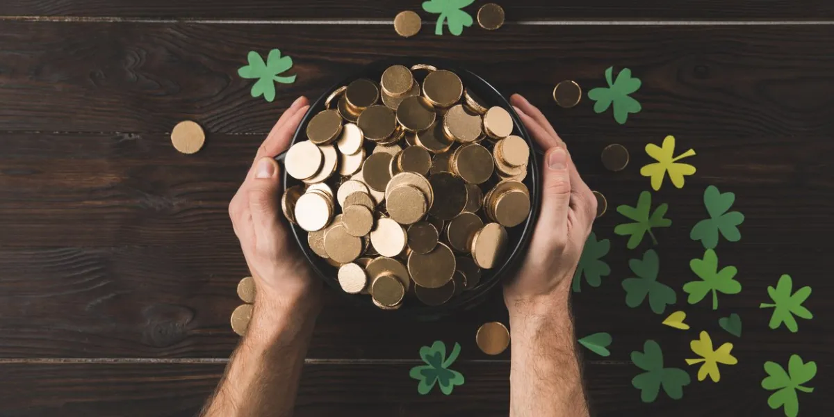 cropped image of man holding pot with golden coins, st patricks day concept