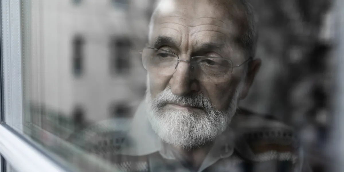 lonely sad older man waiting for his family to visit him