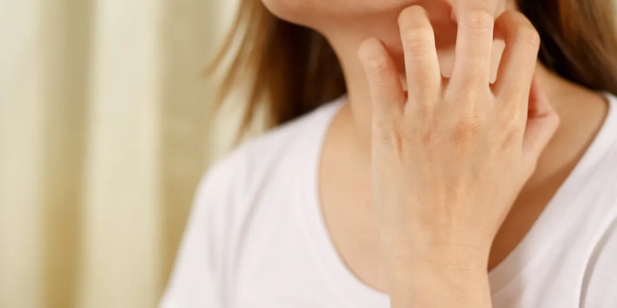 woman suffers from itchy, irritated skin due to covid-19