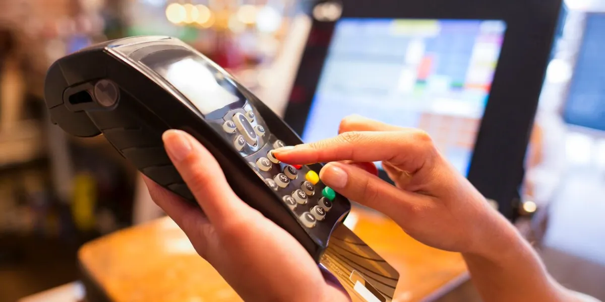 female payment electronic reader close-up shop plastique card button