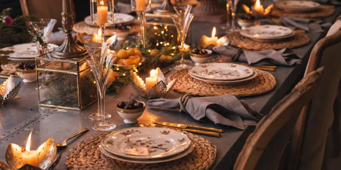 christmas table with candles, flowers and glass cups