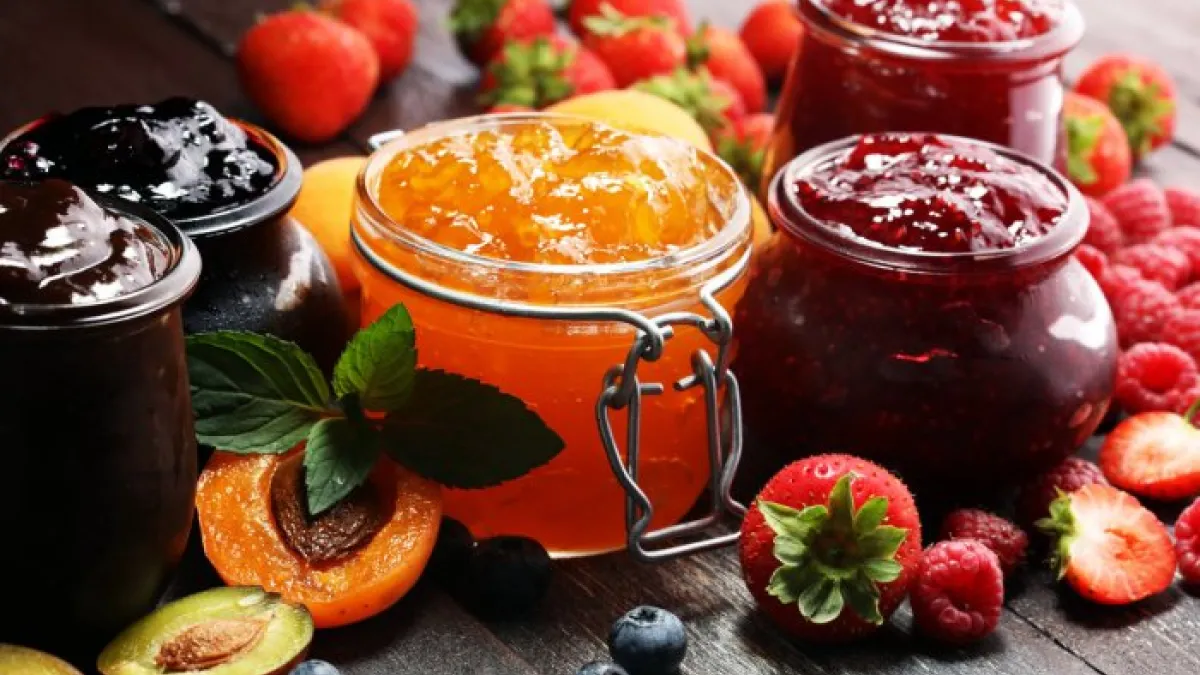 assortment of jams, seasonal berries, apricot, mint and fruits marmalade or confiture